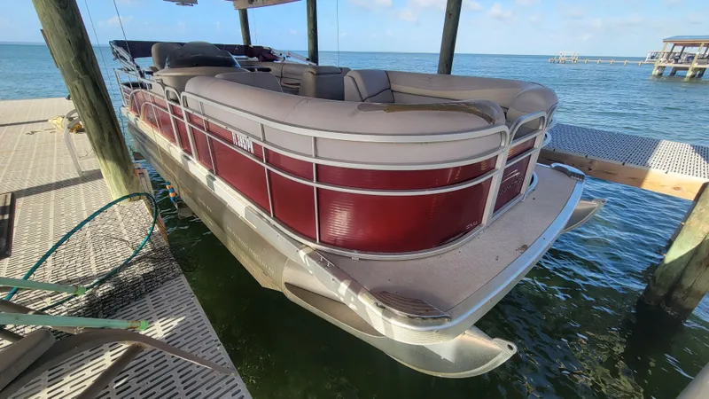 Slide: The Image of 2012 Bennington 2274 GL pontoon boat docked over water. - 10