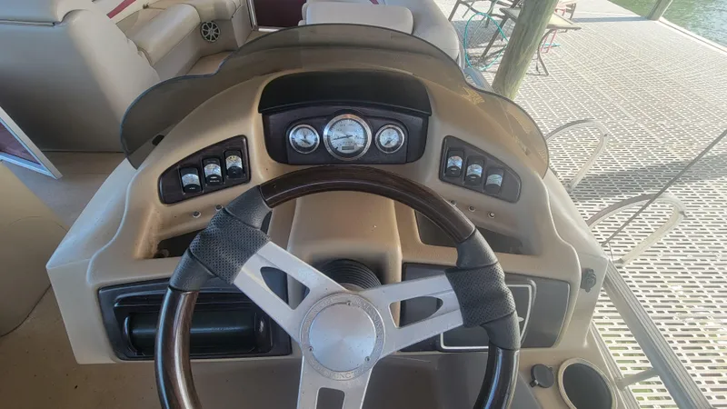 Slide: The Image of Steering console of a 2012 Bennington 2274 GL boat with gauges and controls. - 13