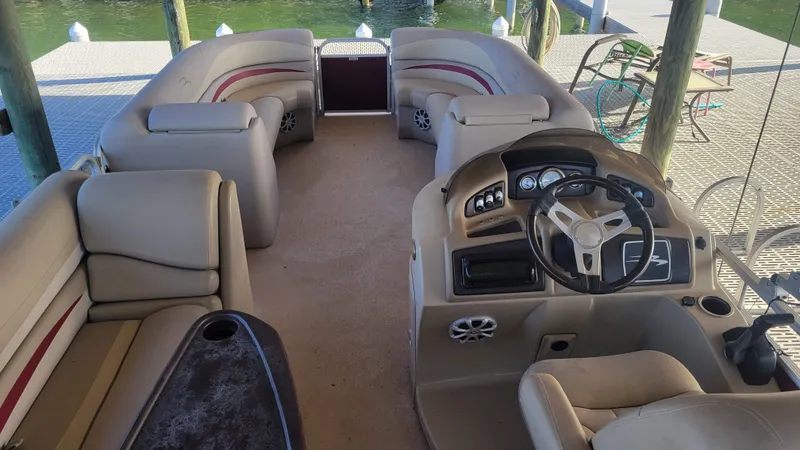 Slide: The Image of 2012 Bennington 2274 GL pontoon boat interior with beige seating and steering console. - 15