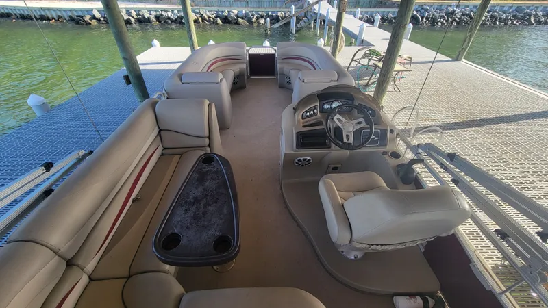 Slide: The Image of 2012 Bennington 2274 GL pontoon boat interior with seating and steering console. - 16