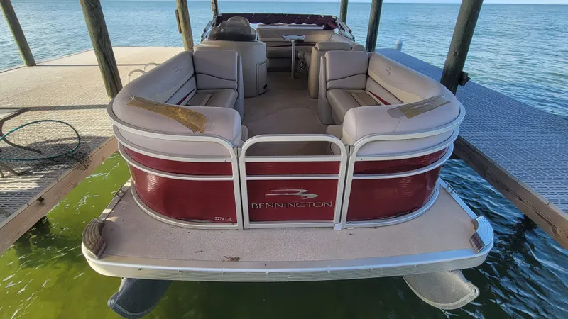 Slide: The Image of 2012 Bennington 2274 GL pontoon boat docked on calm water. - 19