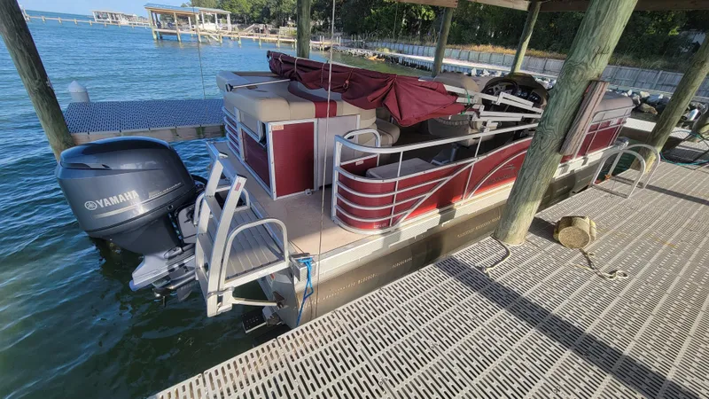 Slide: The Image of 2012 Bennington 2274 GL pontoon boat docked with Yamaha outboard motor. - 2