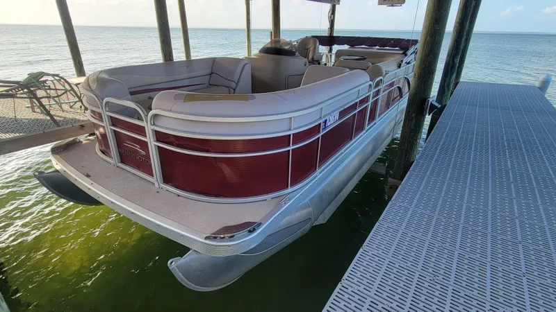 Slide: The Image of 2012 Bennington 2274 GL pontoon boat docked on calm water. - 20