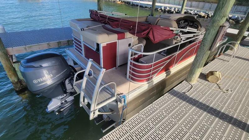 Slide: The Image of 2012 Bennington 2274 GL pontoon boat docked with Yamaha outboard motor. - 3