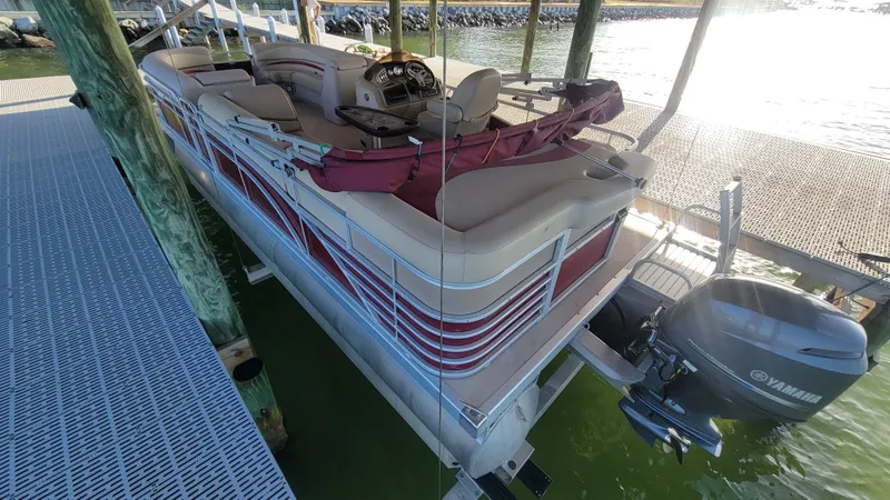 Slide: The Image of 2012 Bennington 2274 GL pontoon boat docked with Yamaha outboard motor. - 4