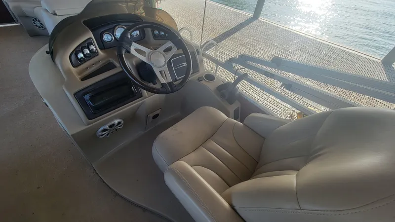 Slide: The Image of Captain's chair and helm of 2012 Bennington 2274 GL boat, featuring beige upholstery. - 6