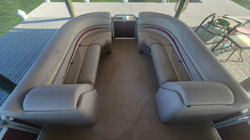 Slide: The Image of 2012 Bennington 2274 GL pontoon boat with spacious seating on a dock. - 7