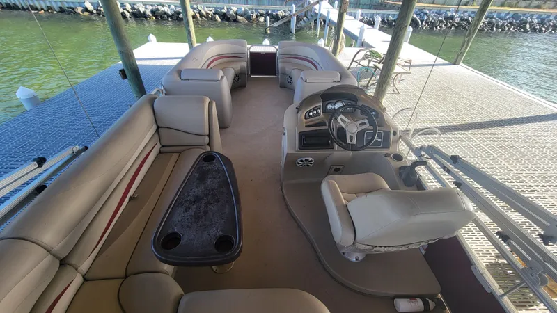 Slide: The Image of 2012 Bennington 2274 GL pontoon boat interior with seating and steering console. - 9