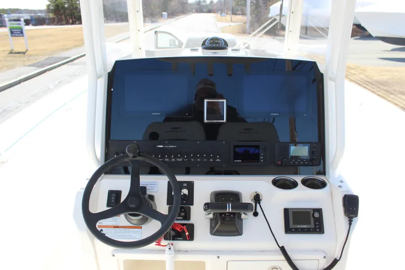Slide: The Image of 2020 Cobia 280 Center Console dashboard with steering wheel and navigation controls. - 4