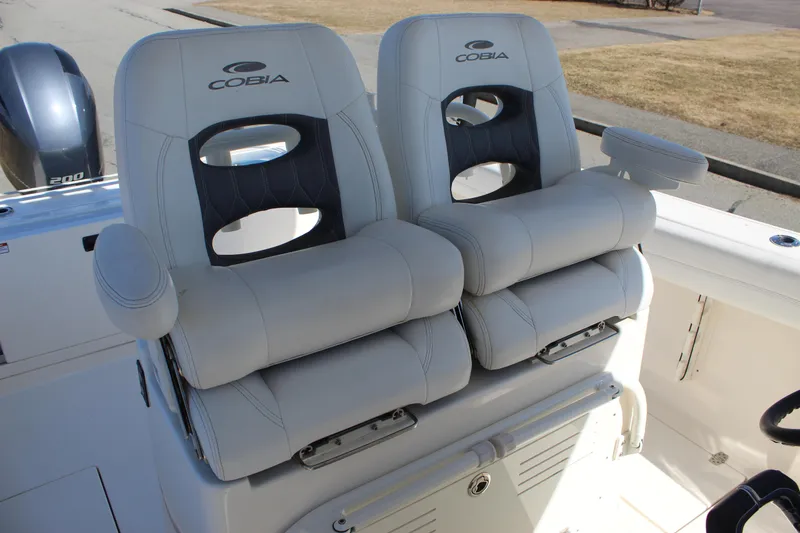 Slide: The Image of 2020 Cobia 280 Center Console boat seats, featuring plush, ergonomic design and armrests. - 6