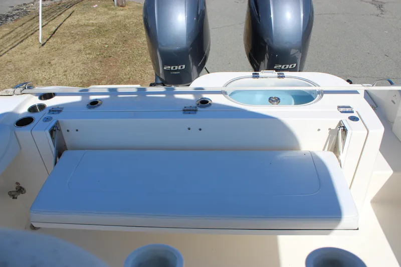 Slide: The Image of 2020 Cobia 280 Center Console boat with dual 200 horsepower engines and seating area. - 8