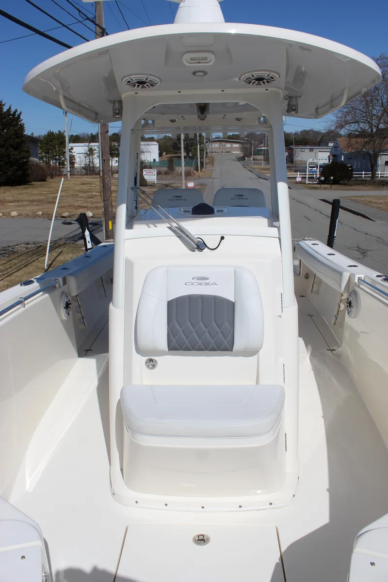 Slide: The Image of 2020 Cobia 280 Center Console boat with white seating and spacious deck. - 9