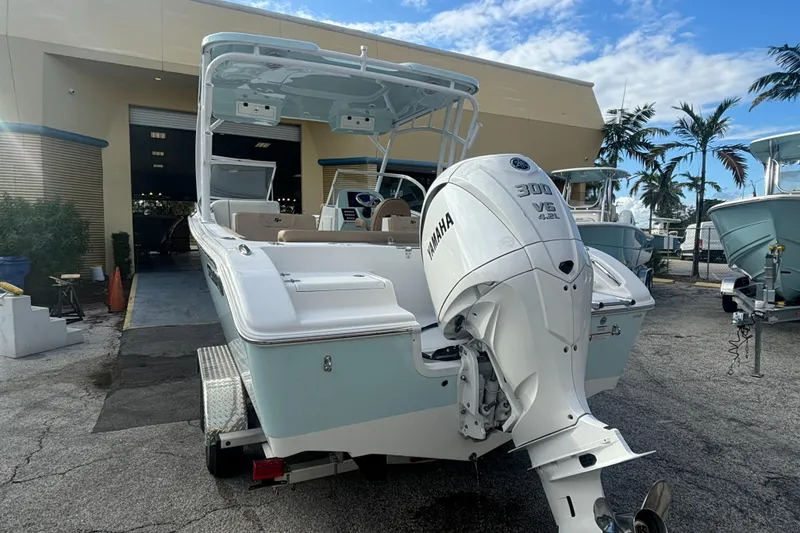 Slide: The Image of 2025 Sea Pro 240 Dual Console boat with Yamaha 300 engine, parked outdoors. - 4