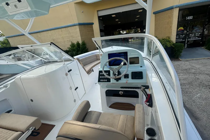 Slide: The Image of 2025 Sea Pro 240 Dual Console boat interior with steering wheel and seating. - 8