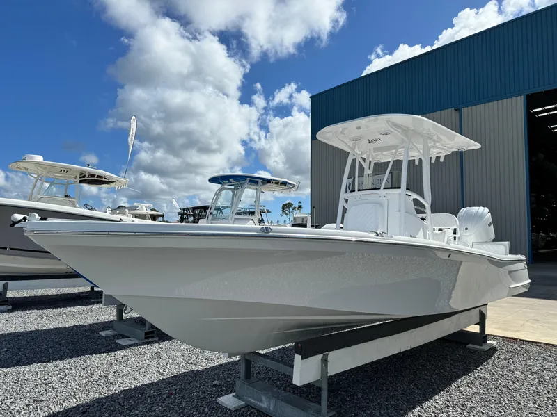 Slide: The Image of 2025 BlackJack 256 Bay boat displayed outdoors under a blue sky. - 1