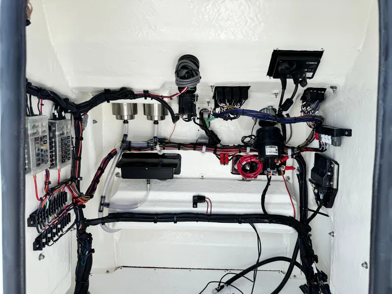 Slide: The Image of 2025 BlackJack 256 Bay boat wiring and electrical components in a clean, organized compartment. - 12