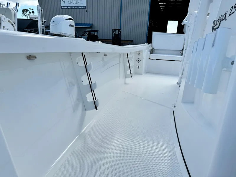 Slide: The Image of 2025 BlackJack 256 Bay boat interior with white deck and storage compartments. - 14