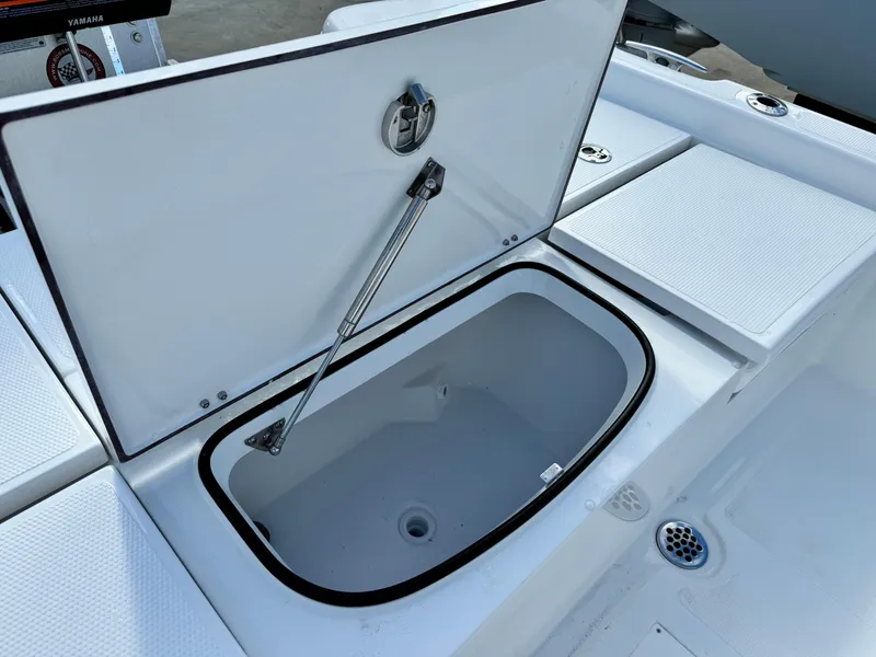 Slide: The Image of Open storage compartment on 2025 BlackJack 256 Bay boat. - 24