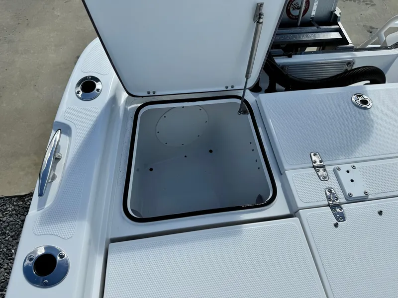 Slide: The Image of Open storage compartment on 2025 BlackJack 256 Bay boat deck. - 25