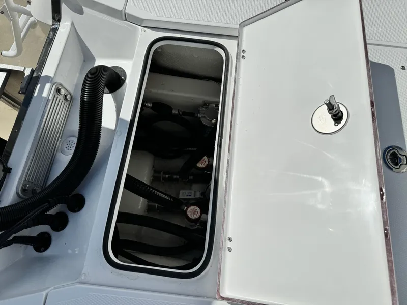 Slide: The Image of Open hatch of 2025 BlackJack 256 Bay boat showing internal components. - 26