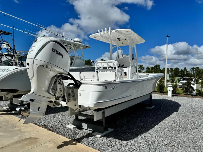 Slide: The Image of 2025 BlackJack 256 Bay boat with Yamaha engine on display under blue sky. - 4