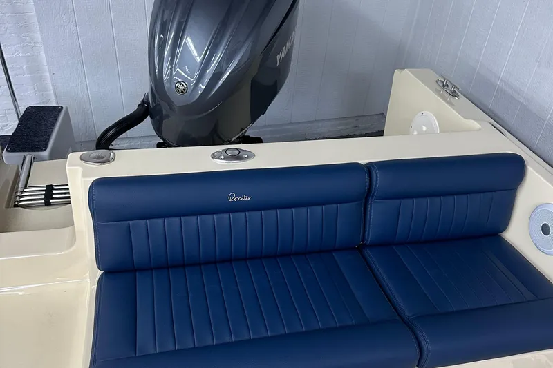Slide: The Image of 2025 Rossiter 23 boat with blue leather seating and Yamaha outboard motor. - 12