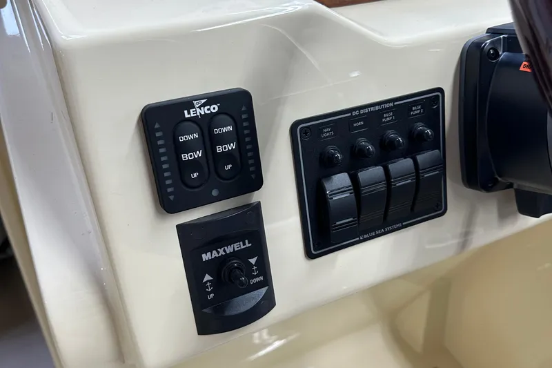 Slide: The Image of Control panel of a 2025 Rossiter 23 boat with Lenco and Maxwell switches. - 15