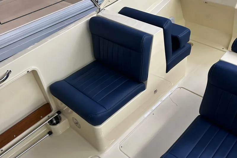 Slide: The Image of 2025 Rossiter 23 boat interior with blue cushioned seating. - 20