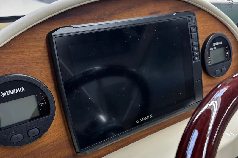 Slide: The Image of 2025 Rossiter 23 dashboard with Garmin display and Yamaha gauges. - 8