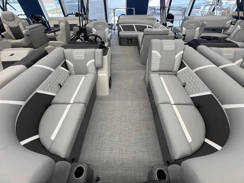 Slide: The Image of 2025 Crest Classic 220 boat interior with gray seating and modern design. - 11