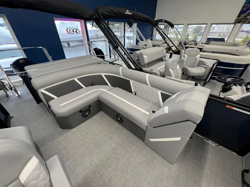 Slide: The Image of 2025 Crest Classic 220 pontoon boat interior with gray seating and modern design. - 7