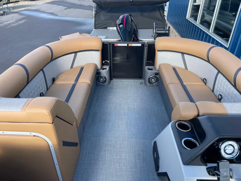 Slide: The Image of 2025 Crest CLASSIC 220 L boat interior with tan seating and modern dashboard. - 11
