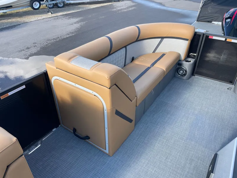 Slide: The Image of 2025 Crest CLASSIC 220 L boat interior with tan seating and gray flooring. - 12