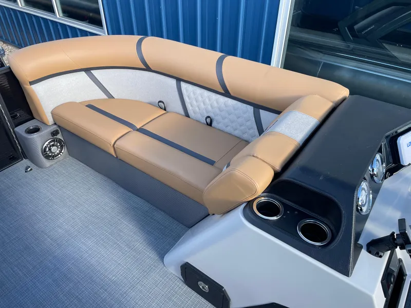 Slide: The Image of 2025 Crest CLASSIC 220 L boat interior with tan seating and modern dashboard. - 13
