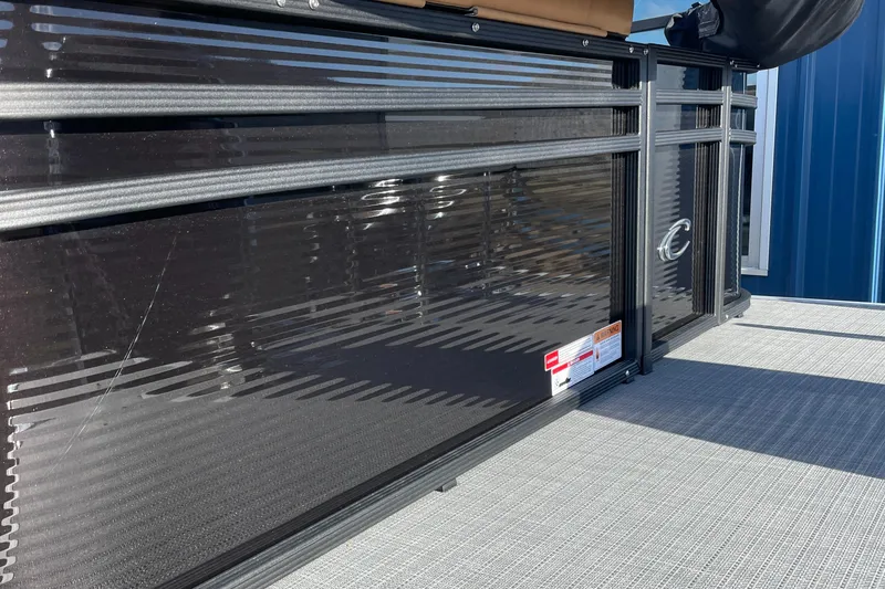 Slide: The Image of 2025 Crest CLASSIC 220 L pontoon boat side view with sleek black paneling. - 19