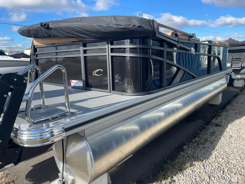 Slide: The Image of 2025 Crest CLASSIC 220 L pontoon boat with sleek black design and aluminum pontoons. - 2