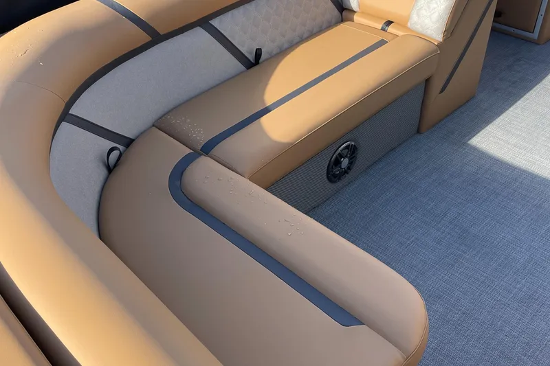 Slide: The Image of 2025 Crest CLASSIC 220 L boat interior with tan seating and modern design. - 4