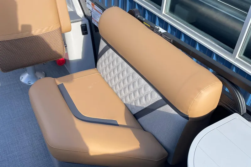 Slide: The Image of 2025 Crest CLASSIC 220 L boat seat with tan upholstery and quilted backrest. - 5