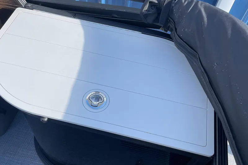 Slide: The Image of 2025 Crest CLASSIC 220 L boat storage compartment with cover. - 6