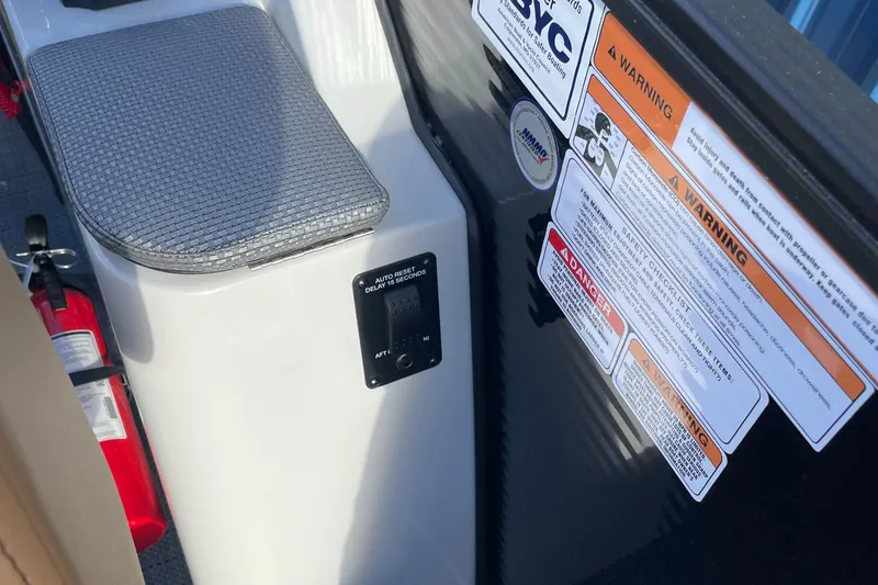 Slide: The Image of Interior of 2025 Crest CLASSIC 220 L boat with safety labels and fire extinguisher. - 7