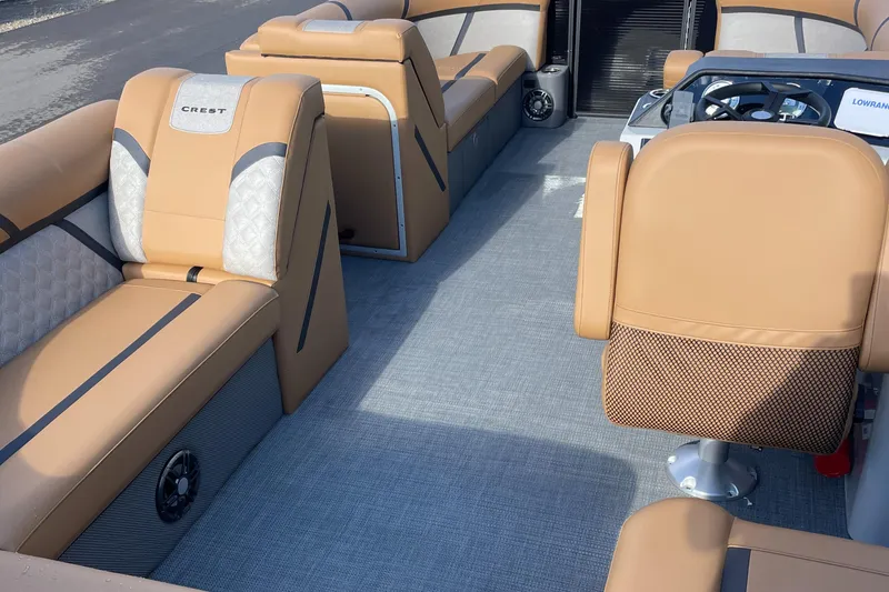 Slide: The Image of 2025 Crest CLASSIC 220 L boat interior with tan seating and modern steering console. - 8