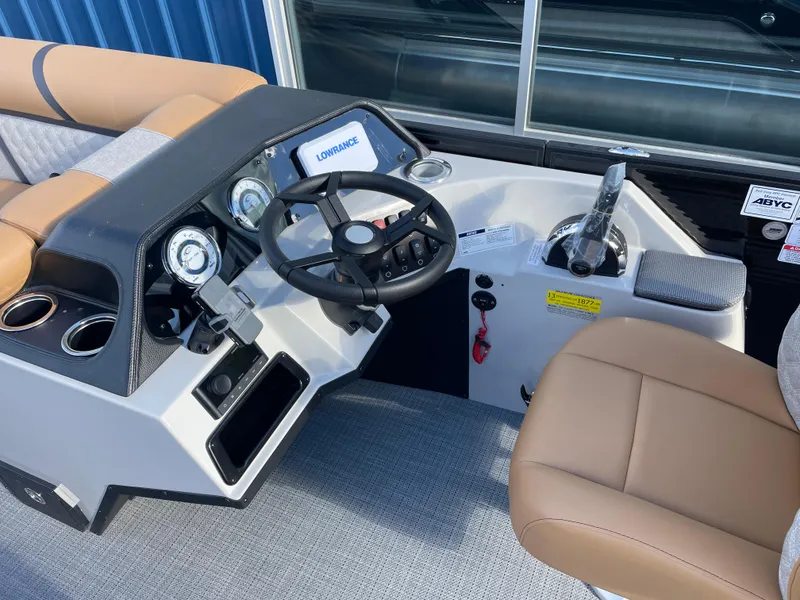 Slide: The Image of 2025 Crest CLASSIC 220 L boat dashboard with steering wheel and controls. - 9