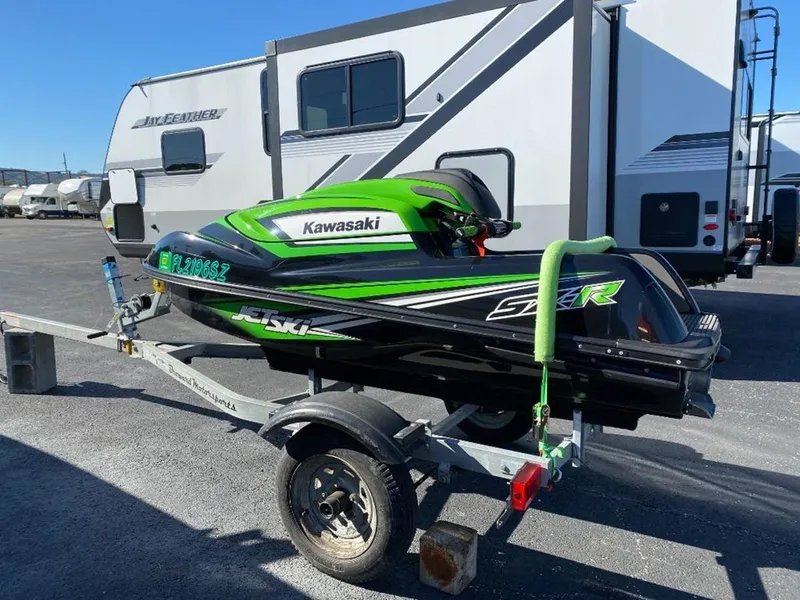 Slide: The Image of 2021 Kawasaki Jetski SX-R on trailer, parked near RVs. - 11