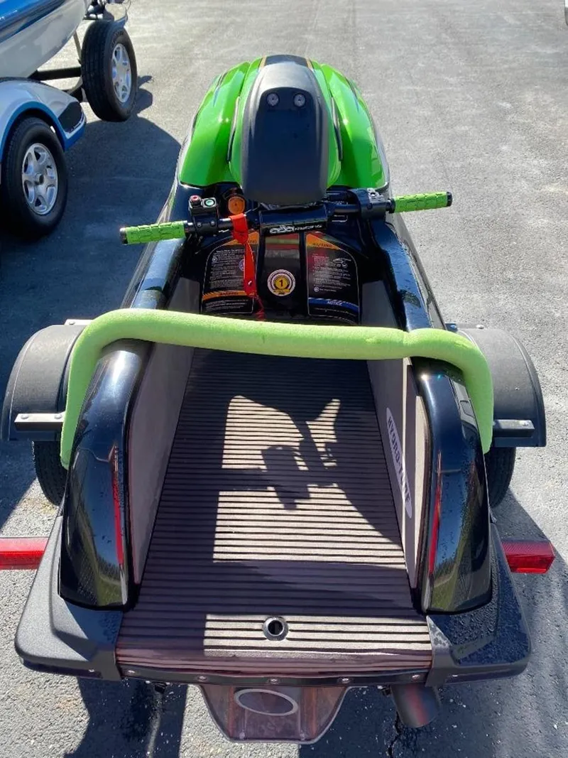 Slide: The Image of 2021 Kawasaki Jetski SX-R in green on a trailer, rear view. - 13