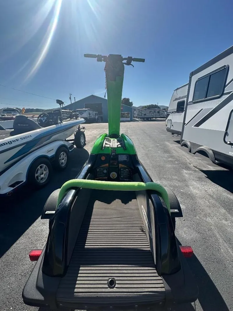 Slide: The Image of 2021 Kawasaki Jetski SX-R in a sunny outdoor setting, parked near trailers. - 17