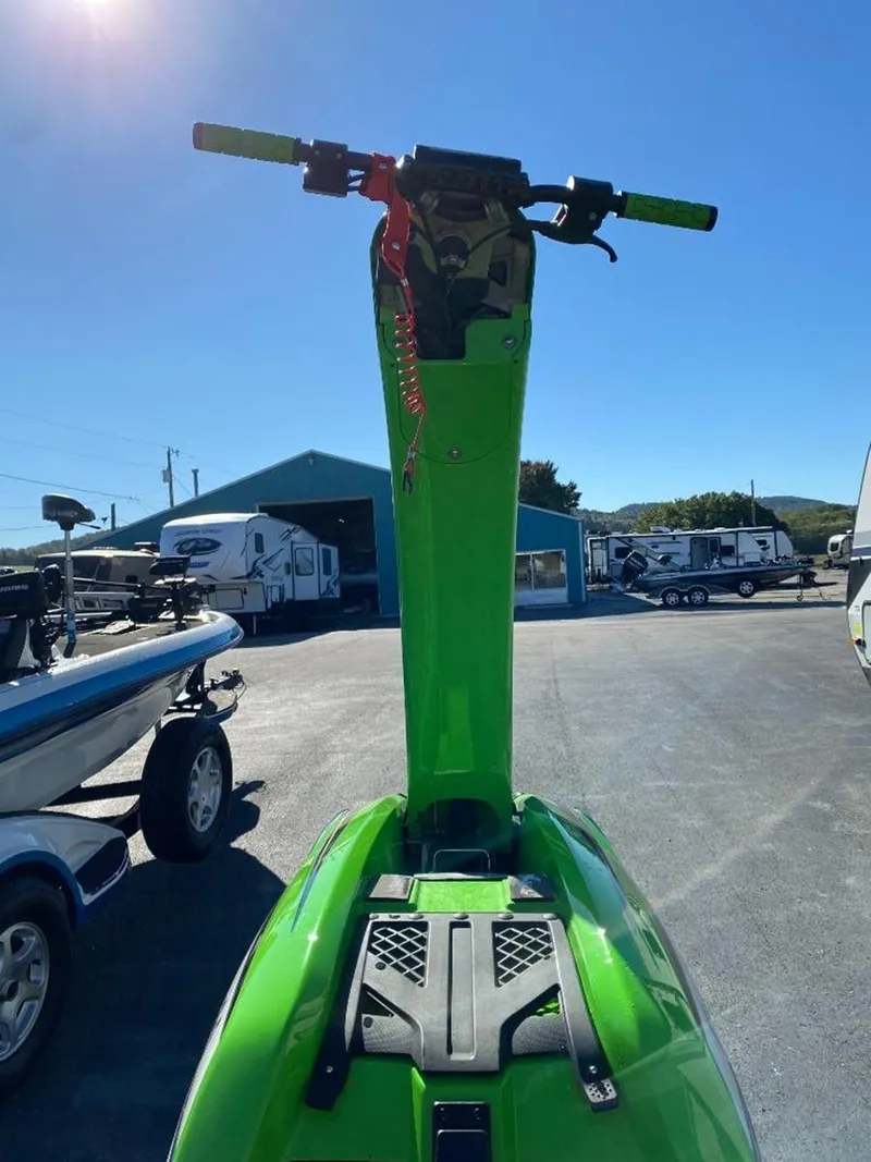 Slide: The Image of 2021 Kawasaki Jetski SX-R in vibrant green, parked outdoors under clear blue sky. - 18