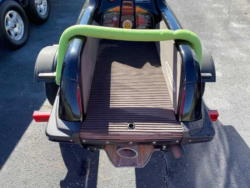 Slide: The Image of 2021 Kawasaki Jetski SX-R rear view with green handlebar, parked on pavement. - 21