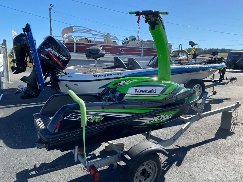 Slide: The Image of 2021 Kawasaki Jetski SX-R on trailer, parked beside boats. - 24