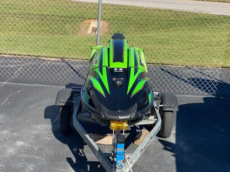 Slide: The Image of 2021 Kawasaki Jetski SX-R in green and black on a trailer. - 6