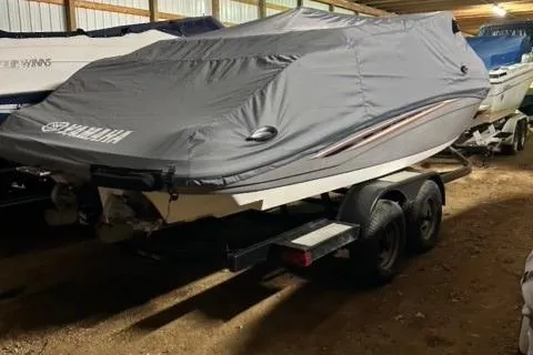 The Image of 2007 Yamaha SX230 boat covered in storage on a trailer. - 1